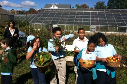 Kids with vegetables at Urban Oaks Farm