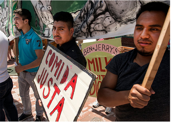 Marchers outside Ben & Jerry’s flagship store in Burlington, Vt., expressing support for a “Milk With Dignity” code of conduct for dairy farmers. Photo credit: Caleb Kenna, New York Times