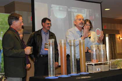 Ray Archuleta, Conservation Agronomist at the USDA Natural Resources and Conservation Service, demonstrates a soil stability test with Vermont farm and food industry leaders at the 2015 Farm to Plate Annual Gathering