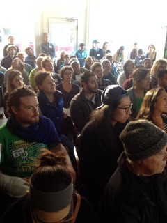 A standing-room-only crowd listens to a workshop on farmer co-ops.