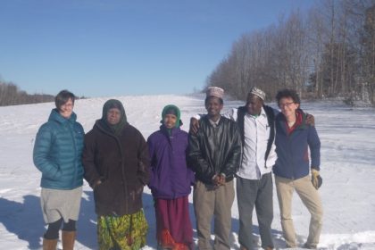Farmers with MFT and Cultivating Community staff in the snow on the land.