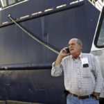 Carlos Rafael on the phone in front of a boat Photo credit: Peter Pereira/Standard-Times File/SCMG