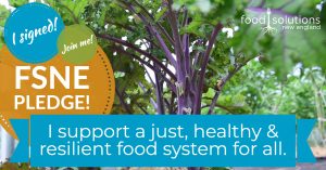 Close-up of a plant with the text “FSNE Pledge! I support a just, healthy and resilient food system for all”