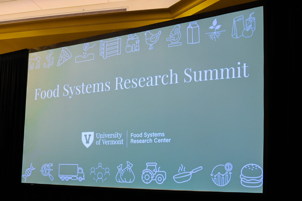 Picture of a presentation up on a screen with title that reads "Food System Research Summit"