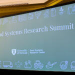 Picture of a presentation up on a screen with title that reads "Food System Research Summit"